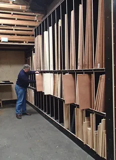 Visitor browsing wood panel racks in a showroom