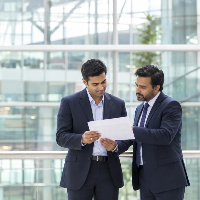 Two colleagues reviewing a customer document