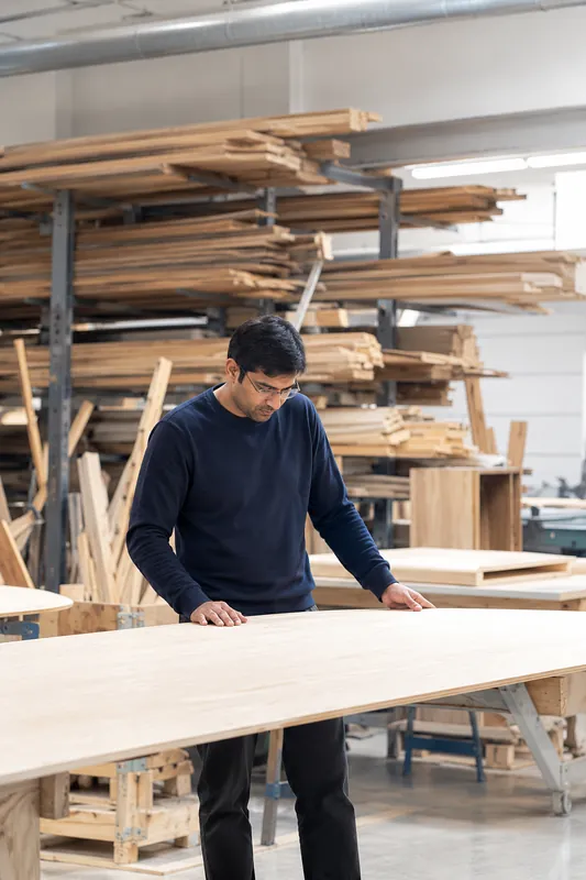 Craftsman working on a wood panel in the workshop