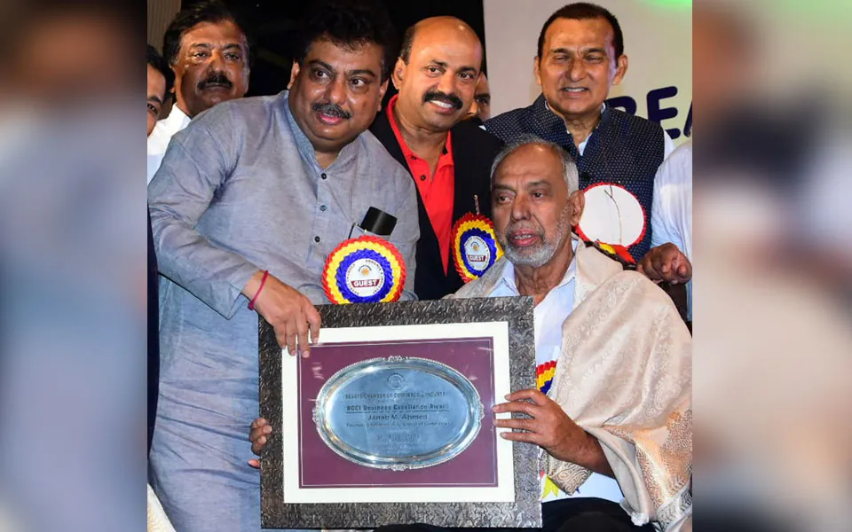 A.K. Ahmed receiving the BCCI Business Excellence Award on stage