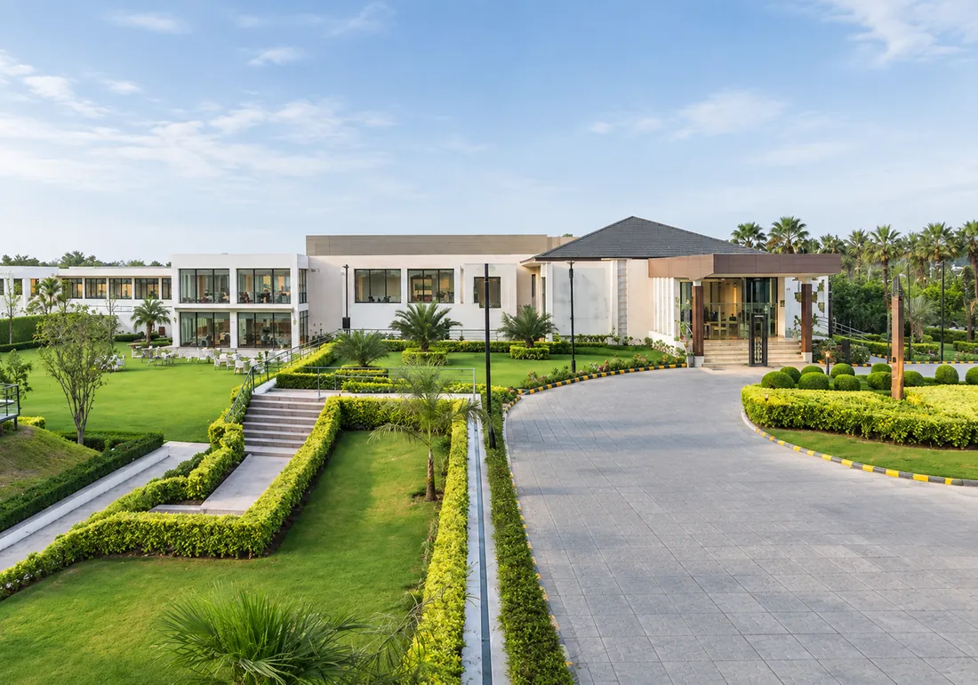 Four Points by Sheraton, New Delhi, with a tree-lined driveway